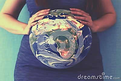 Pregnant woman with a globe instead of a belly. The concept of the miracle of life, the connection with the planet Stock Photo