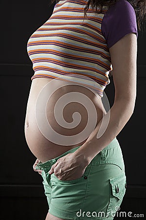 Pregnant woman green shorts Stock Photo