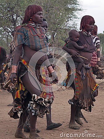 Pregnant woman from the Hamar tribe chants and dances during the bull jumping ceremony Editorial Stock Photo