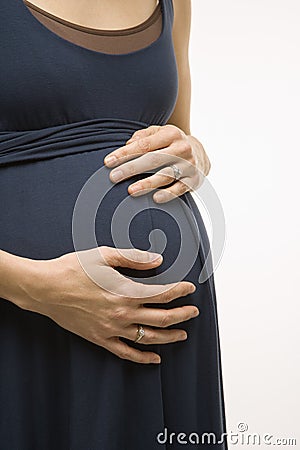 Pregnant woman with hands on belly. Stock Photo