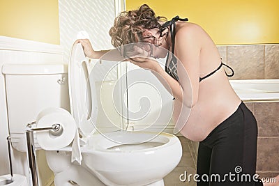 Pregnant woman having morning sickness during Pregnancy. Concept Stock Photo
