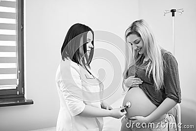 Pregnant woman having ultrasonic scanning at the clinic Stock Photo