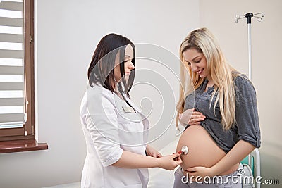 Pregnant woman having ultrasonic scanning at the clinic Stock Photo