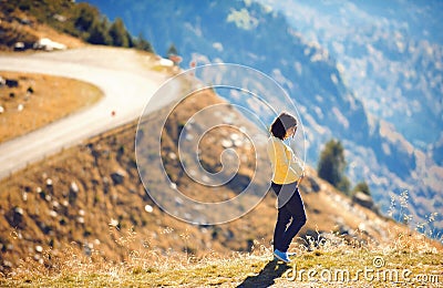 Pregnant woman on hill with great view Stock Photo