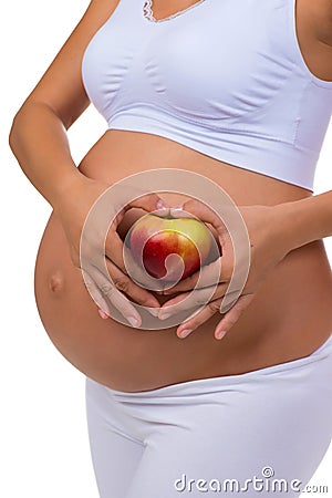 Pregnant woman holding an apple. Vitamins and healthy food during pregnancy Stock Photo