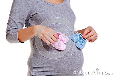 Pregnant woman holding baby booties. Stock Photo