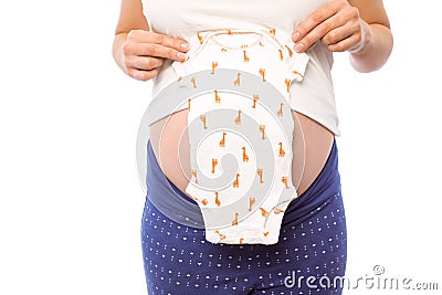 Pregnant woman holding baby clothes Stock Photo