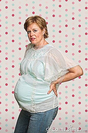 Pregnant Woman Holding Back Stock Photo