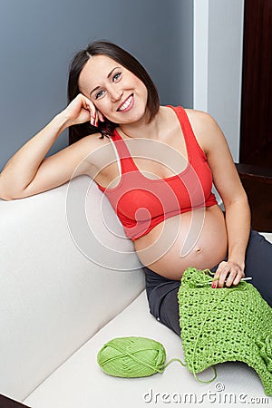 Pregnant woman holding crocheting Stock Photo