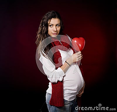 Pregnant woman holding heart Stock Photo