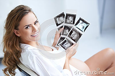 Pregnant woman holding her USG pictures Stock Photo