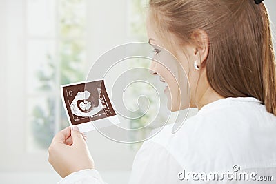 Pregnant woman holding sonogram Stock Photo