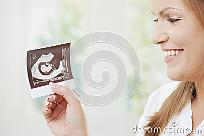 Pregnant woman holding sonogram Stock Photo