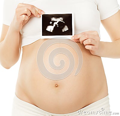 Pregnant woman holding ultrasound photo of embryo baby in belly Stock Photo