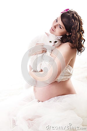 Pregnant woman holding white furry cat. Stock Photo