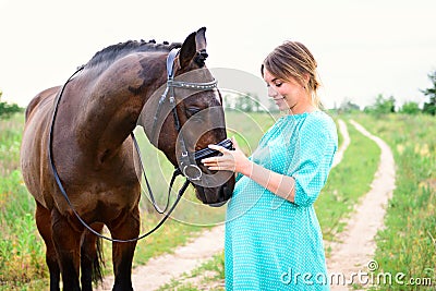 Pregnant woman with horse Stock Photo