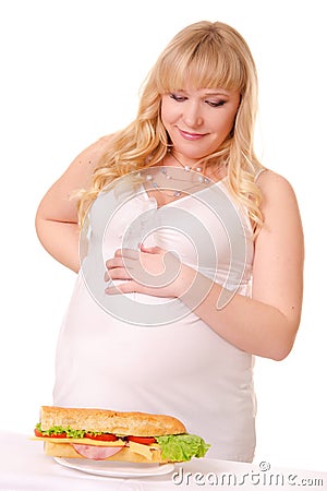 Pregnant woman with huge sandwich Stock Photo