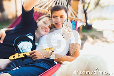 Pregnant woman and husband, resting in a hammock Stock Photo