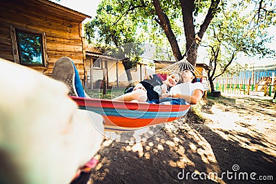 Pregnant woman and husband, resting in a hammock Stock Photo