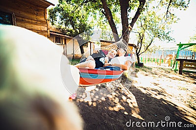 Pregnant woman and husband, resting in a hammock Stock Photo