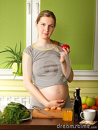 Pregnant Woman On Kitchen Stock Photo