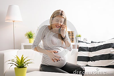 Pregnant woman in labor calling hospital Stock Photo