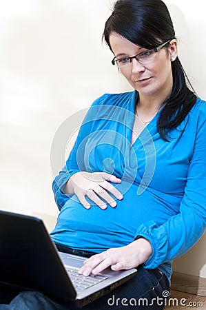 Pregnant woman and laptop Stock Photo