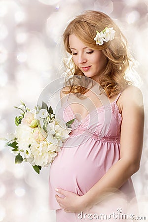 Pregnant woman looking at belly Stock Photo