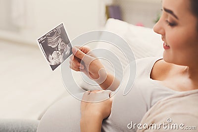 Pregnant woman looking at her baby sonography Stock Photo