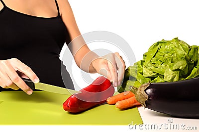 Pregnant woman is making a vegetable salad Stock Photo