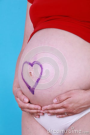 Pregnant woman with painted heart Stock Photo