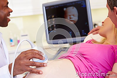 Pregnant Woman And Partner Having 4D Ultrasound Scan Stock Photo