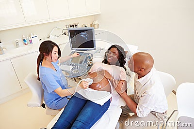 Pregnant Woman And Partner Having 4D Ultrasound Scan Stock Photo