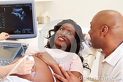 Pregnant Woman And Partner Having 4D Ultrasound Scan Stock Photo