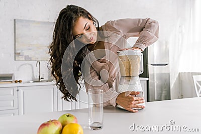 Pregnant woman preparing tasty smoothie in blender Stock Photo