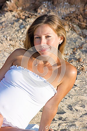 Pregnant woman rests on the beach Stock Photo