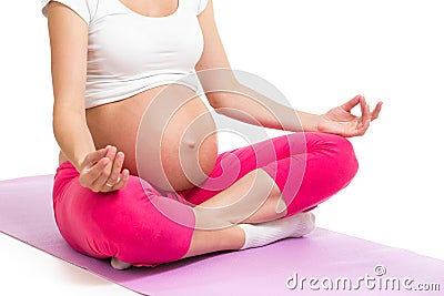 Pregnant woman sitting in yoga lotus position Stock Photo