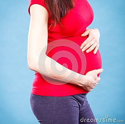 Pregnant woman with stomach pain touching her belly, aches in pregnancy and risk of miscarriage Stock Photo