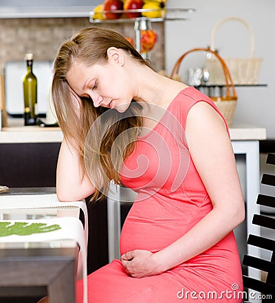 Pregnant woman with strong pain of stomach Stock Photo