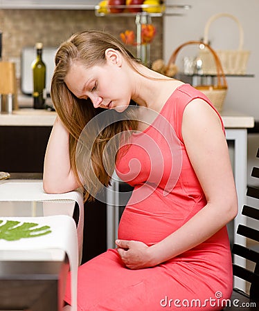 Pregnant woman with strong pain of stomach Stock Photo