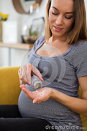 Pregnant Woman Taking Folic Acid Tablets Stock Photo