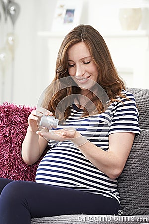 Pregnant Woman Taking Folic Acid Tablets Stock Photo