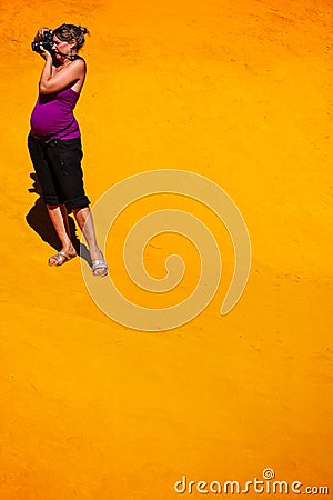 Pregnant woman taking photos in ocher quarry in roussillon Stock Photo