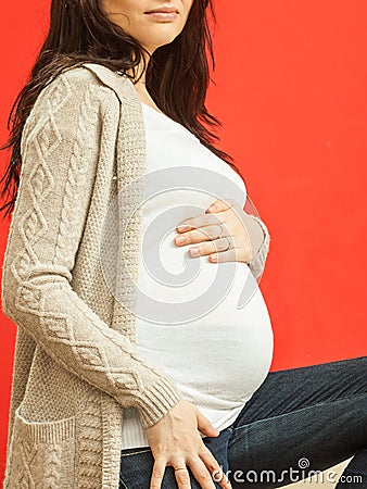 Pregnant woman in white clothes showing belly Stock Photo