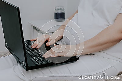 Pregnant woman working on a laptop. Stock Photo