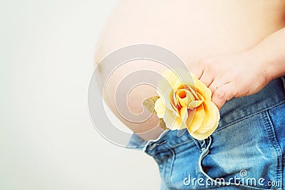 Pregnant woman with yellow flower Stock Photo