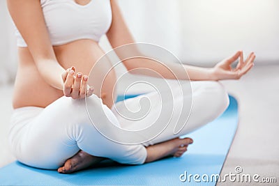 Pregnant Woman Yoga. Close Up Pregnant Girl Exercising Stock Photo