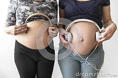 Pregnant women turn on music for babies Stock Photo