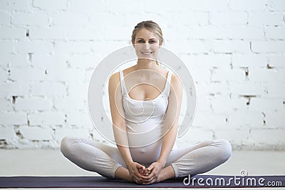 Pregnant young woman doing prenatal yoga. Butterfly Pose Stock Photo