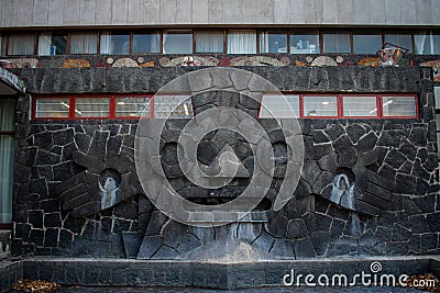 Prehispanic sculpture and fountain on a stone wall Stock Photo